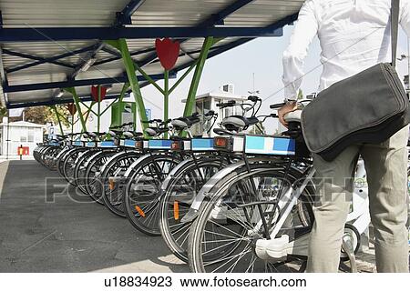 Stock Image - Electric bicycle sharing system. Fotosearch