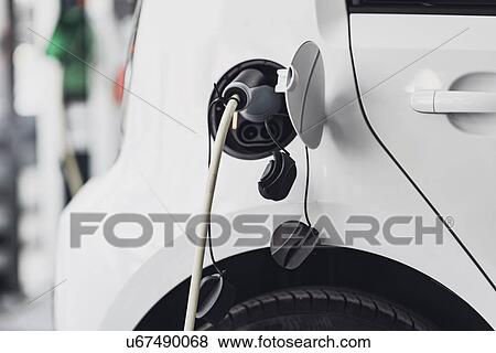 Electric car charging View Large Photo Image Stock Photo - Electric car charging. Fotosearch