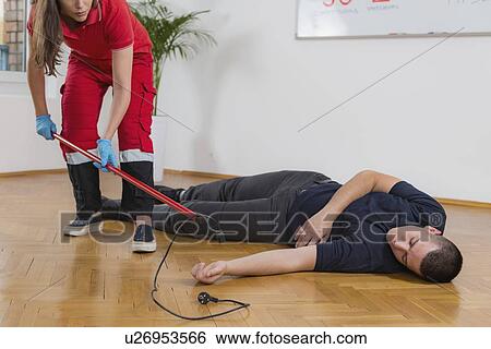 Stock Photograph - Electric shock fist aid training. Fotosearch