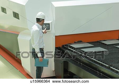 Picture - Engineer working in factory. Fotosearch