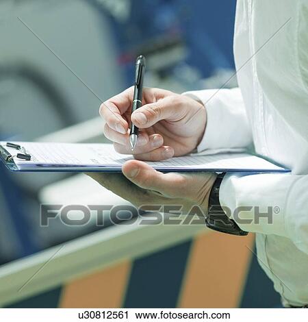 Stock Image - Engineer working in factory. Fotosearch