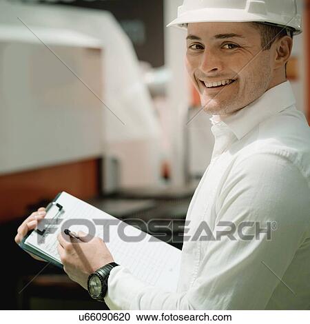 Stock Image - Engineer working in factory. Fotosearch