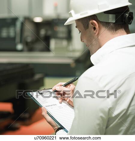 Engineer working in factory View Large Photo Image Stock Image - Engineer working in factory. Fotosearch