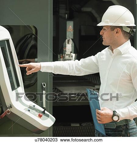 Stock Image - Engineer working in factory. Fotosearch
