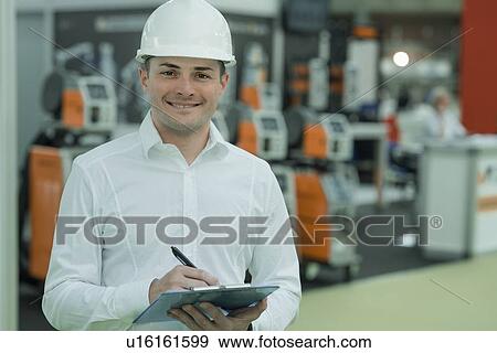 Engineer working in factory View Large Photo Image Stock Photo - Engineer working in factory. Fotosearch