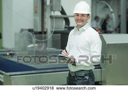 Stock Photo - Engineer working in factory. Fotosearch