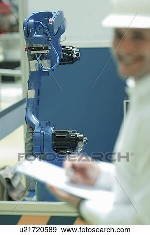 Engineer working in factory View Large Photo Image Stock Photo - Engineer working in factory. Fotosearch