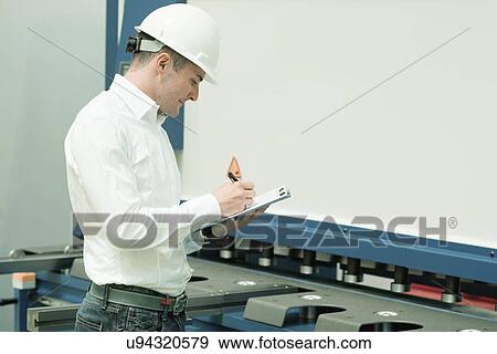 Engineer working in factory View Large Photo Image Stock Photo - Engineer working in factory. Fotosearch