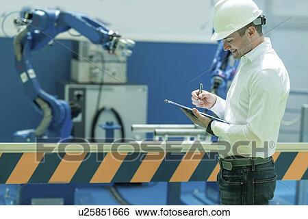 Stock Photograph - Engineer working in factory. Fotosearch
