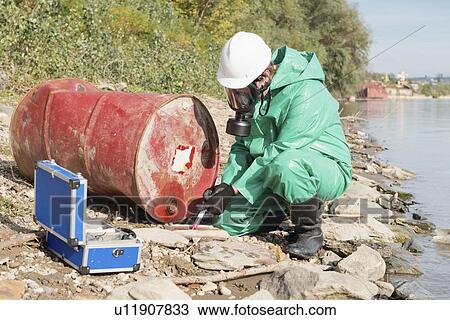 Stock Image - Examination of chemical leak. Fotosearch