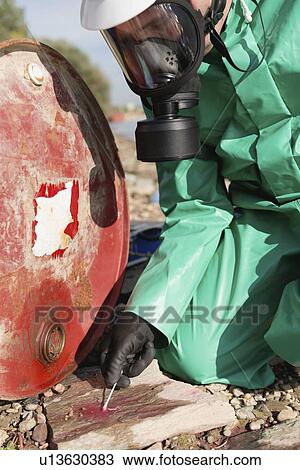 Stock Image - Examination of chemical leak. Fotosearch