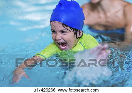 Excited boy in swimming pool View Large Photo Image Stock Photograph - Excited boy in swimming pool. Fotosearch