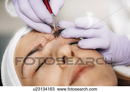 Stock Image - Eyebrow microblading. Fotosearch