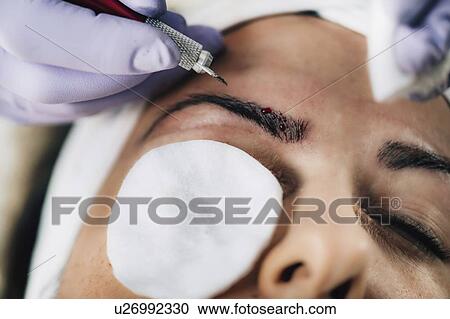 Stock Image - Eyebrow microblading. Fotosearch
