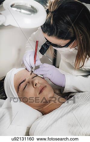 Stock Image - Eyebrow microblading. Fotosearch