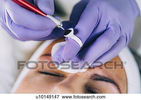 Stock Photo - Eyebrow microblading. Fotosearch