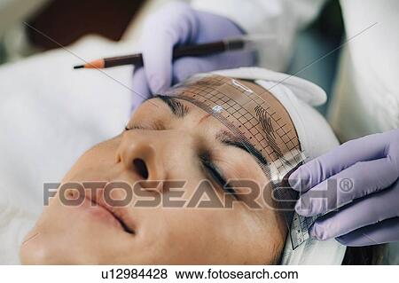 Stock Photo - Eyebrow microblading. Fotosearch