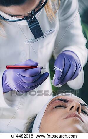 Stock Photo - Eyebrow microblading. Fotosearch