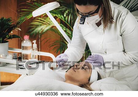 Stock Photograph - Eyebrow microblading. Fotosearch