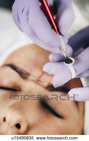 Stock Photography - Eyebrow microblading. Fotosearch