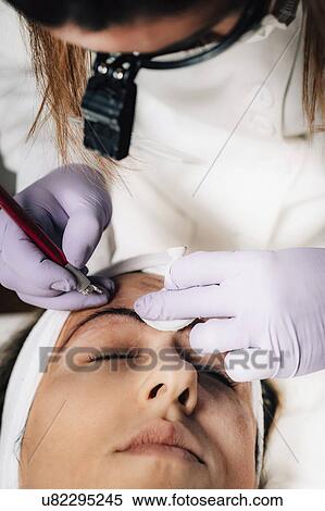 Stock Photography - Eyebrow microblading. Fotosearch