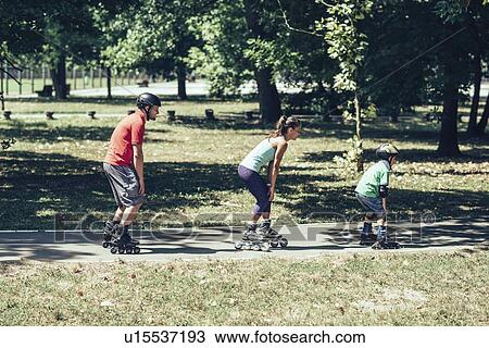 Family roller skating in park View Large Photo Image Stock Image - Family roller skating in park. Fotosearch