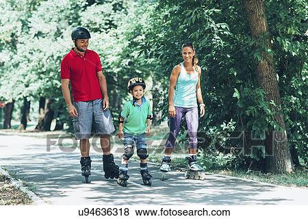 Family roller skating in park View Large Photo Image Stock Photo - Family roller skating in park. Fotosearch
