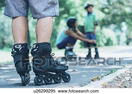 Stock Photography - Family roller skating in park. Fotosearch