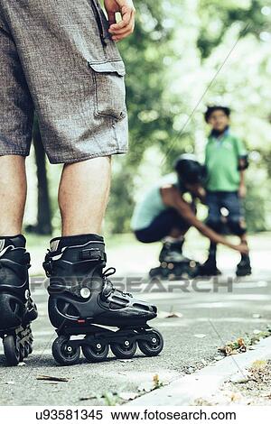Family roller skating in park View Large Photo Image Stock Photography - Family roller skating in park. Fotosearch