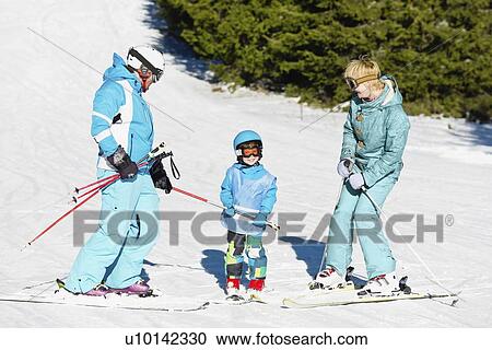 Stock Image - Family skiing. Fotosearch