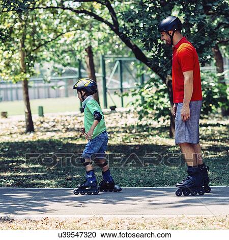Father and son roller skating in park View Large Photo Image Stock Image - Father and son roller skating in park. Fotosearch