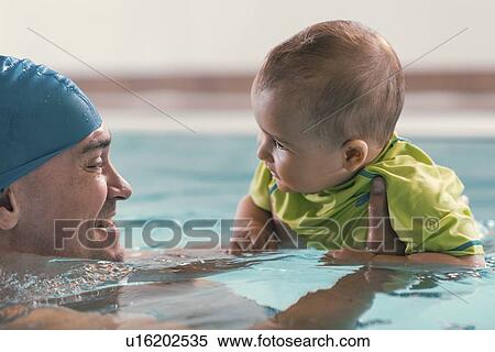 Stock Photography - Father with baby boy in the swimming pool. Fotosearch