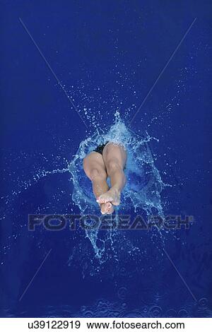 Female diver entering water View Large Photo Image Stock Photo - Female diver entering water. Fotosearch