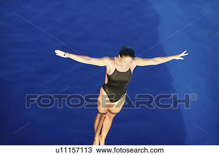 Stock Image - Female diver on platform. Fotosearch