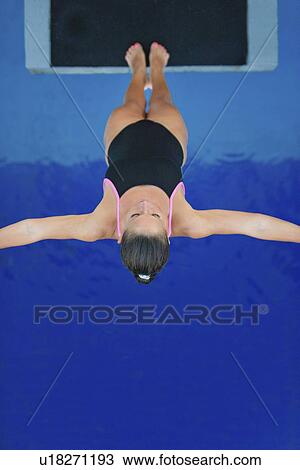 Stock Image - Female diver on platform. Fotosearch