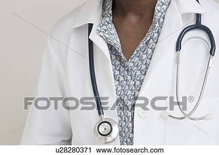 Stock Image - Female doctor wearing stethoscope. Fotosearch