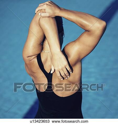 Stock Image - Female swimmer warming up. Fotosearch