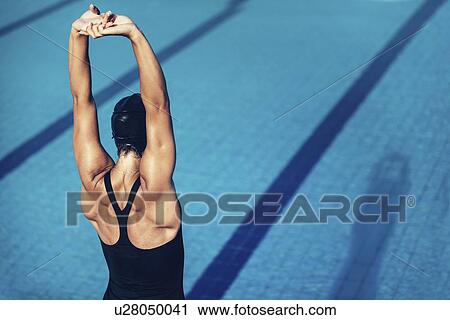 Stock Image - Female swimmer warming up. Fotosearch