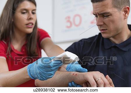 Stock Image - First aid training for burns. Fotosearch
