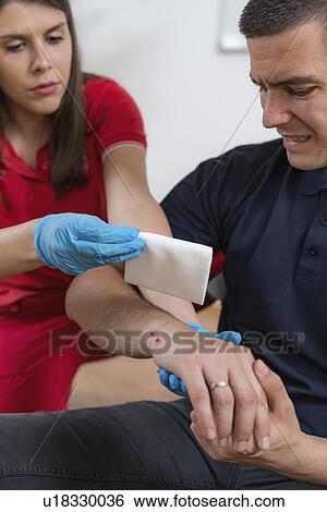 Stock Photograph - First aid training for burns. Fotosearch