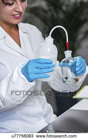Stock Image - Food safety inspector working in laboratory. Fotosearch