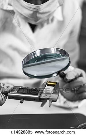 Forensic investigator examining evidence in lab View Large Photo Image Stock Photography - Forensic investigator examining evidence in lab. Fotosearch