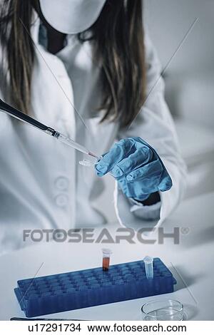 Picture - Forensics expert examining crime scene evidence. Fotosearch