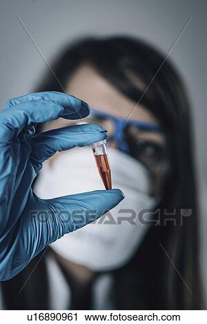 Stock Image - Forensics expert examining crime scene evidence. Fotosearch
