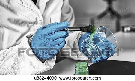 Stock Image - Forensics expert examining crime scene evidence. Fotosearch