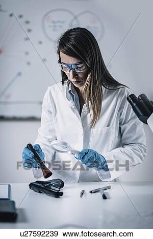 Forensics expert examining crime scene evidence View Large Photo Image Stock Photo - Forensics expert examining crime scene evidence. Fotosearch