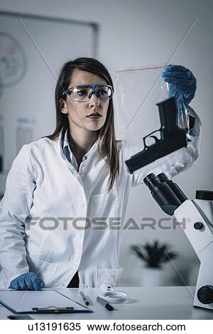 Forensics expert examining crime scene evidence View Large Photo Image Stock Photography - Forensics expert examining crime scene evidence. Fotosearch