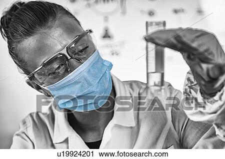 Stock Image - Forensics expert examining evidence. Fotosearch