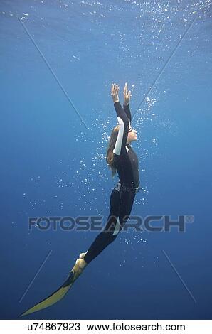 Stock Image - Free diver ascending. Fotosearch