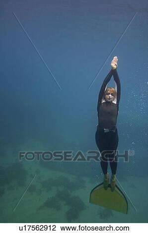 Stock Image - Free diver underwater. Fotosearch